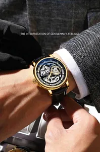 Close-up of men's skeleton automatic watch with gold case and black leather strap
