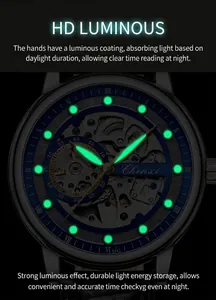 Close-up of luminous watch hands and markers on a skeleton mechanical watch face