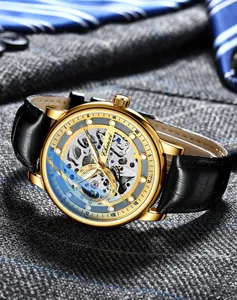 Close-up of a men's golden automatic skeleton mechanical watch with black leather strap