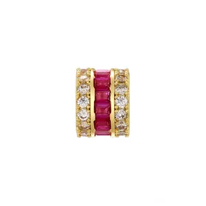 Close-up of gold-plated spacer bead with ruby red baguette and clear round zircons