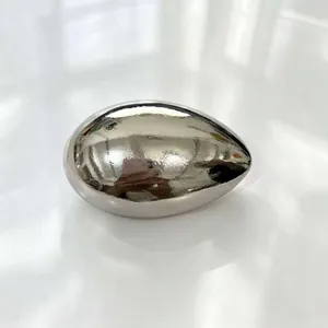 Close-up of a silver metallic egg-shaped accessory with a high-polish mirror finish.