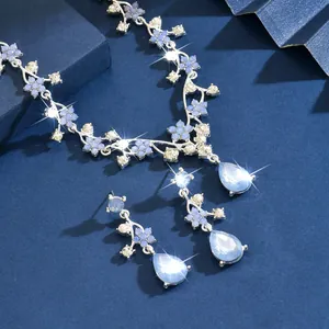 Detailed macro view of the blue floral vintage necklace and teardrop crystal earrings
