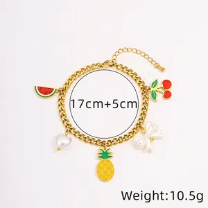 Detail view of gold titanium steel bracelet with colorful fruit and bow charms