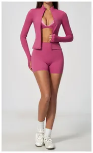 Detailed view of women's magenta zip-up sports jacket and tight high-waisted gym shorts