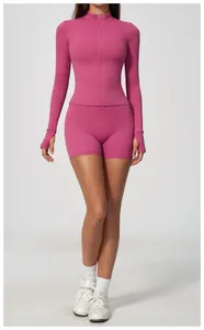 Front view of a women's pink long-sleeve athletic zipper top and matching shorts set.