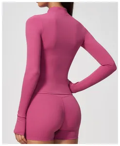 Back view of magenta long-sleeved mock neck yoga top with matching athletic shorts set
