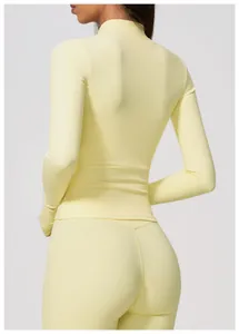 Back view of a light yellow long-sleeve tight yoga top paired with matching high-waisted leggings