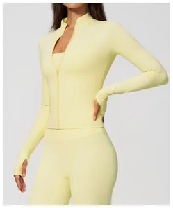 Close-up of yellow slim fit zip-up sports jacket and high-waisted yoga leggings for women