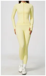 Front view of pastel yellow zip-up athletic jacket and leggings set for women's yoga