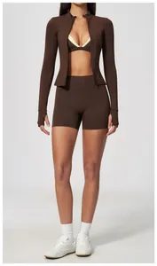Full body view of women's brown zip-up sports jacket set with high-waisted shorts