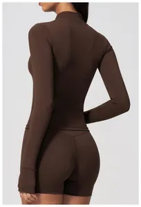 Detail back view of a brown slim-fit long sleeve yoga top with high-stretch fabric.