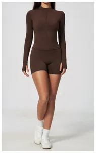 Detailed view of a coffee brown zipper activewear set with long sleeve top and shorts