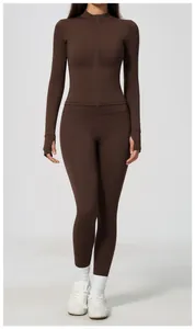 Full-body detail of women's dark brown zip-up athletic jacket and leggings yoga set.