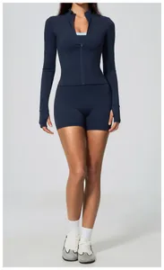 Full view of navy blue long sleeve zip-up yoga top and matching biker shorts.