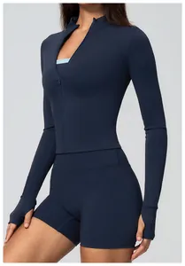 Close-up detail of the slim-fit navy blue zipper yoga jacket and high-waisted gym shorts