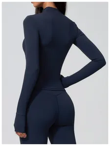 Back view detail of breathable navy blue long-sleeved yoga top and sports leggings