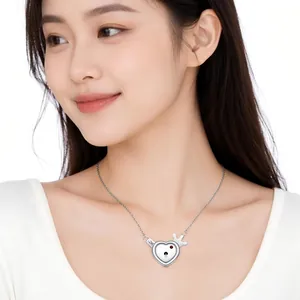 Detailed view of stainless steel heart lock necklace with key charm on model neck