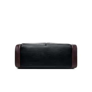Detailed view of the reinforced bottom of the large capacity soft leather handbag.