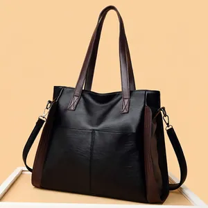 Detailed view of black soft leather tote bag with brown straps and large capacity
