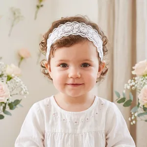 Elegant white lace headband with delicate floral embroidery worn by a cute baby girl