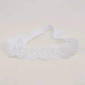 Detailed view of white floral embroidery on soft elastic lace baby headband accessory