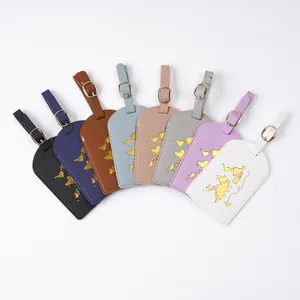 Detailed view showing multiple colorful PVC luggage tags with gold foil world map