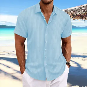 Macro view of blue men's jacquard cotton linen short sleeve shirt with textured pattern
