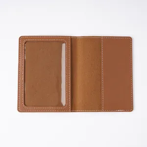 Interior detail of a brown leather passport holder with a transparent ID window slot