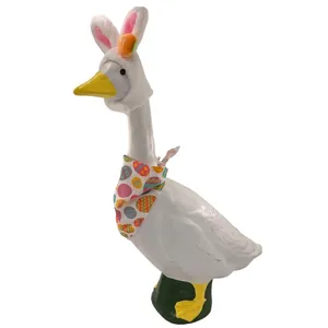 Detail view of 23 inch white porch goose with Easter bunny ears and egg pattern bandana