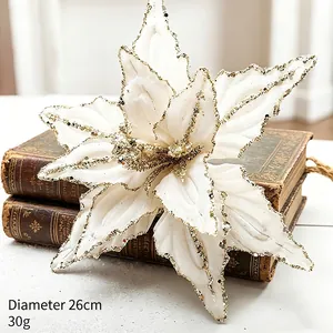 Detailed macro view of white velvet artificial Christmas flower featuring gold glitter edges