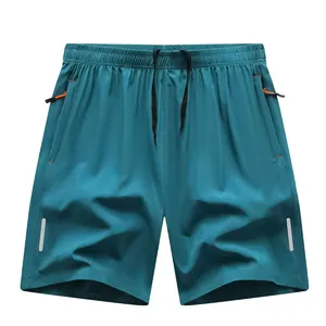 Pantaloncini sportivi asciugatura rapida verde petrolio con lacci riflettenti