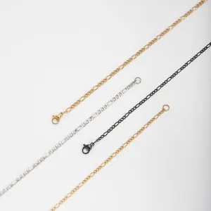 Detailed view of stainless steel Figaro chains in gold, silver, and black finishes.