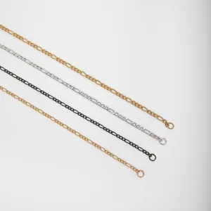 Detail view of stainless steel Figaro link chains in gold, silver, and black finishes.