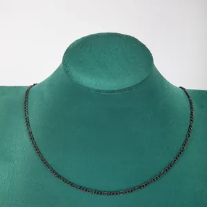 Detailed view of a dark stainless steel 3:1 Figaro chain necklace on a green bust