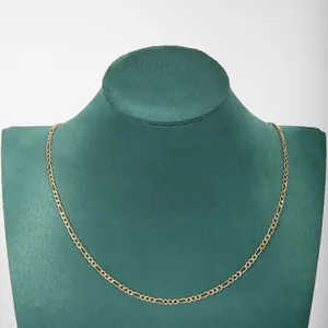 Classic gold-plated stainless steel Figaro chain necklace displayed on green jewelry bust