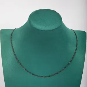 Minimalist stainless steel 3:1 NK chain necklace on a green velvet display stand.