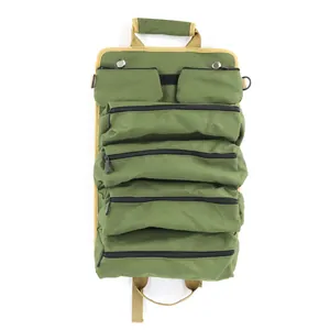 Detailed view of heavy-duty green canvas multi-pocket roll-up car tool organizer