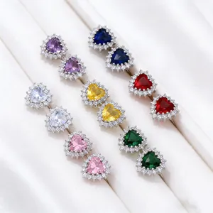 Close-up of multi-colored heart-shaped stud earrings with halo cubic zirconia stones.
