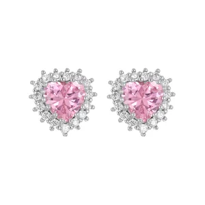 Close-up of pink heart-shaped cubic zirconia stud earrings with halo setting.