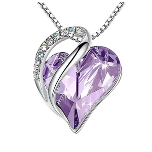 Elegant heart pendant necklace with faceted purple crystal and sparkling accents.