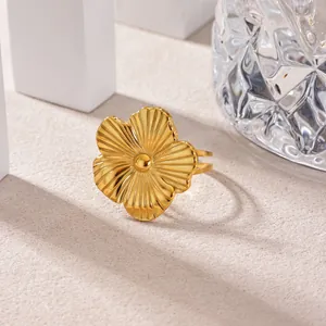 Close-up of an elegant gold stainless steel flower ring featuring textured petals