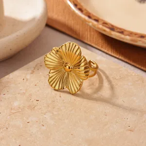 Close-up detail of a gold stainless steel flower ring with elegant ribbed petal texture