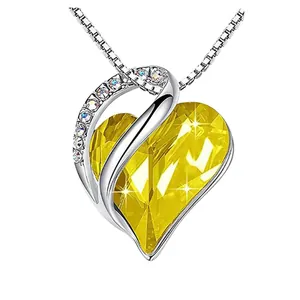 Detailed shot of sparkling yellow heart-shaped birthstone pendant necklace on silver chain