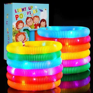 Close-up of stacked colorful glowing pop tubes with LED lights and cartoon gift packaging