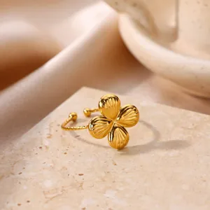 Macro view of detailed golden flower ring with textured petals and twisted band