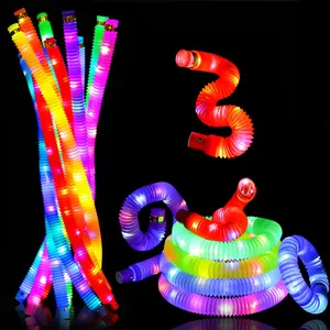 Detail view of colorful LED glowing pop tubes showing flexible shapes on black backdrop.