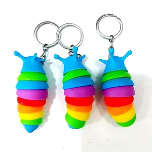 Detailansicht von drei regenbogenfarbenen, gegliederten Fidget-Schnecken-Schlüsselanhängern.