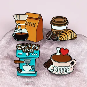 Detailed close-up of four cute coffee-themed enamel pins on a pink textured base.