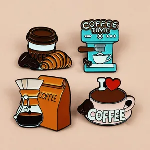 Detailed view of four creative coffee-themed enamel pins on a soft beige background