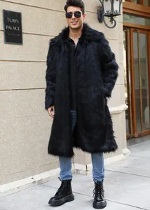 Man wearing a long black faux fur winter coat with a square collar in an urban setting